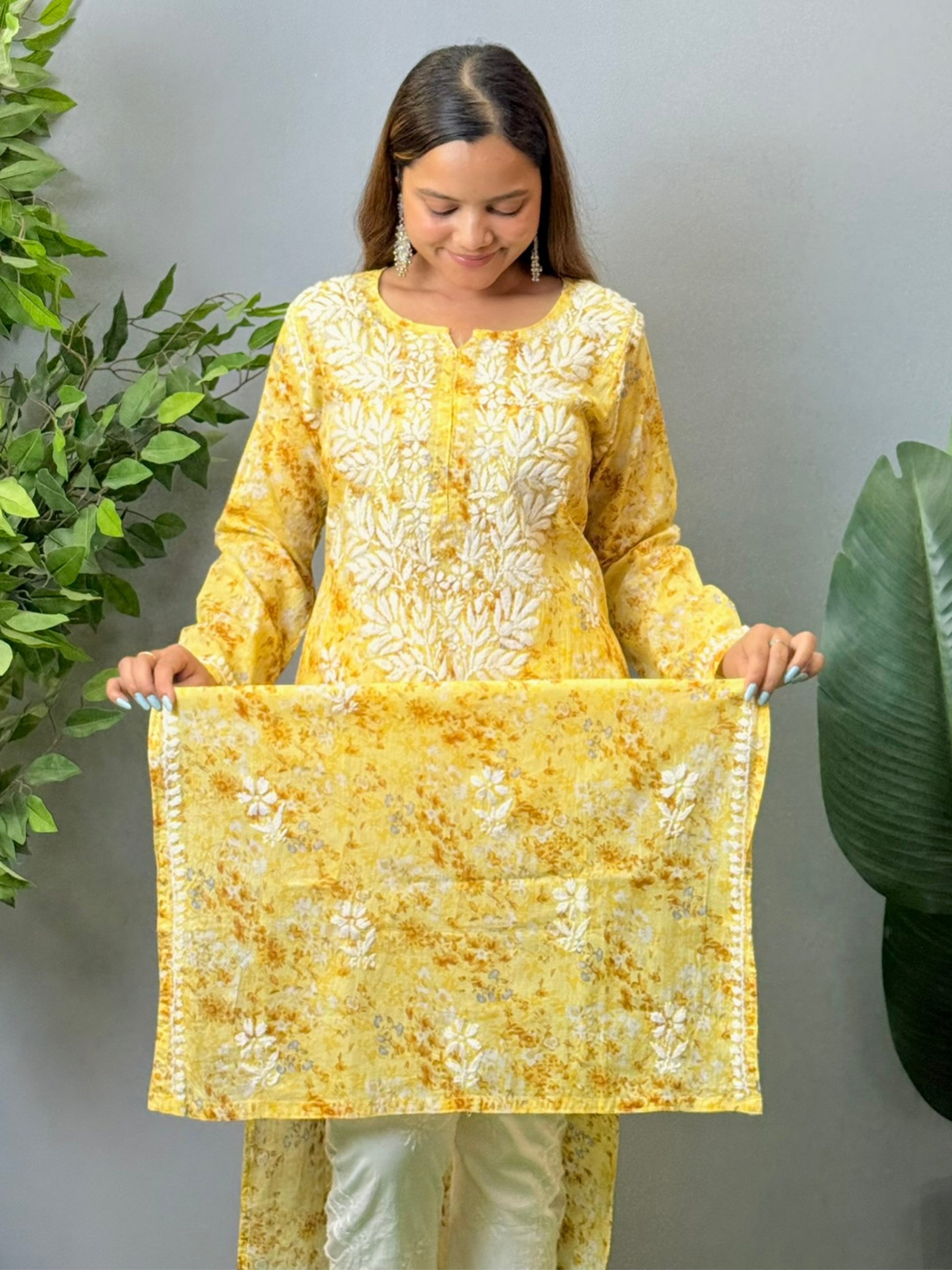 Model wearing a yellow printed mulmul chikankari kurta with white embroidery – perfect for summer