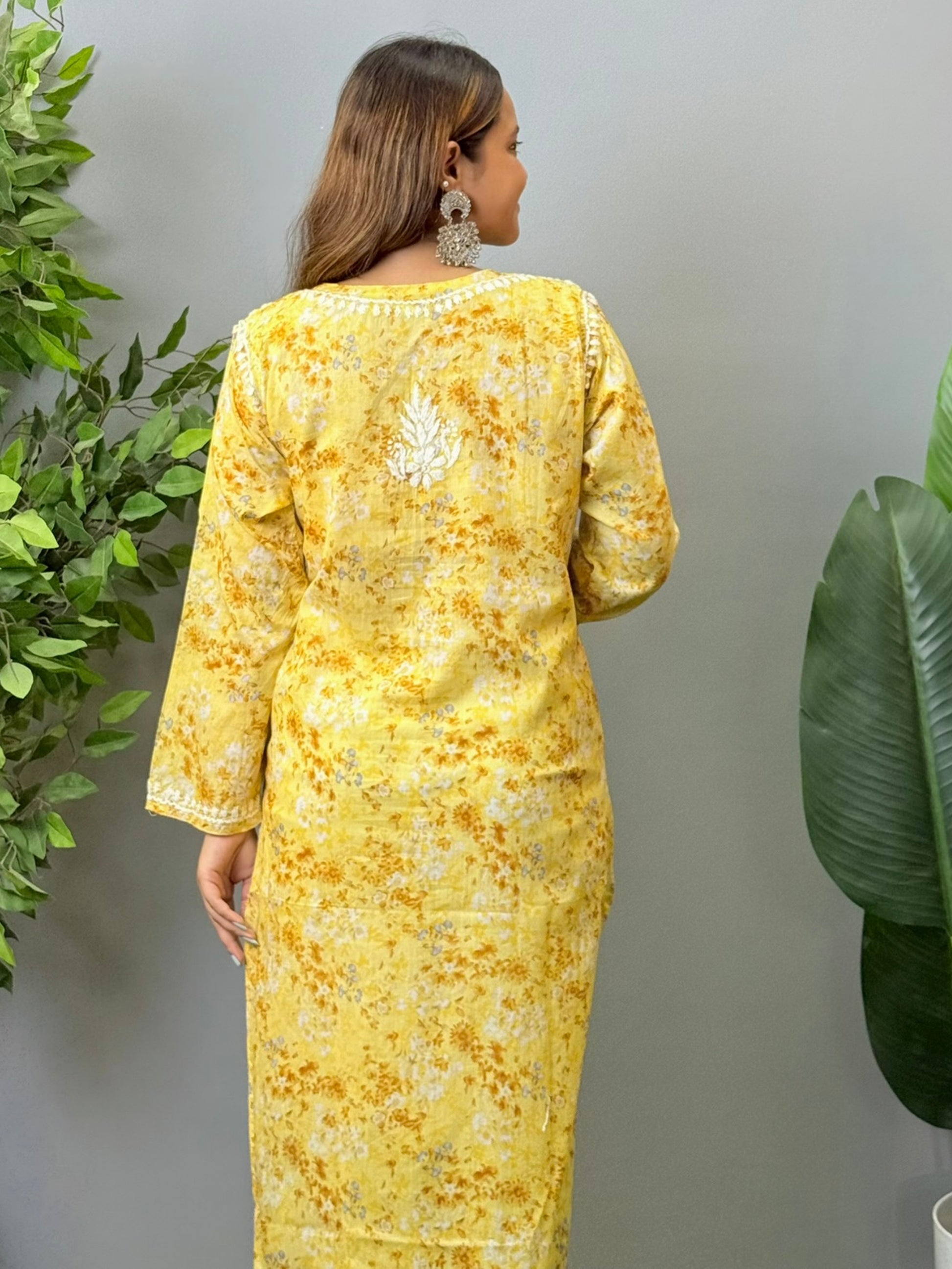 Model wearing a yellow printed mulmul chikankari kurta with white embroidery – perfect for summer