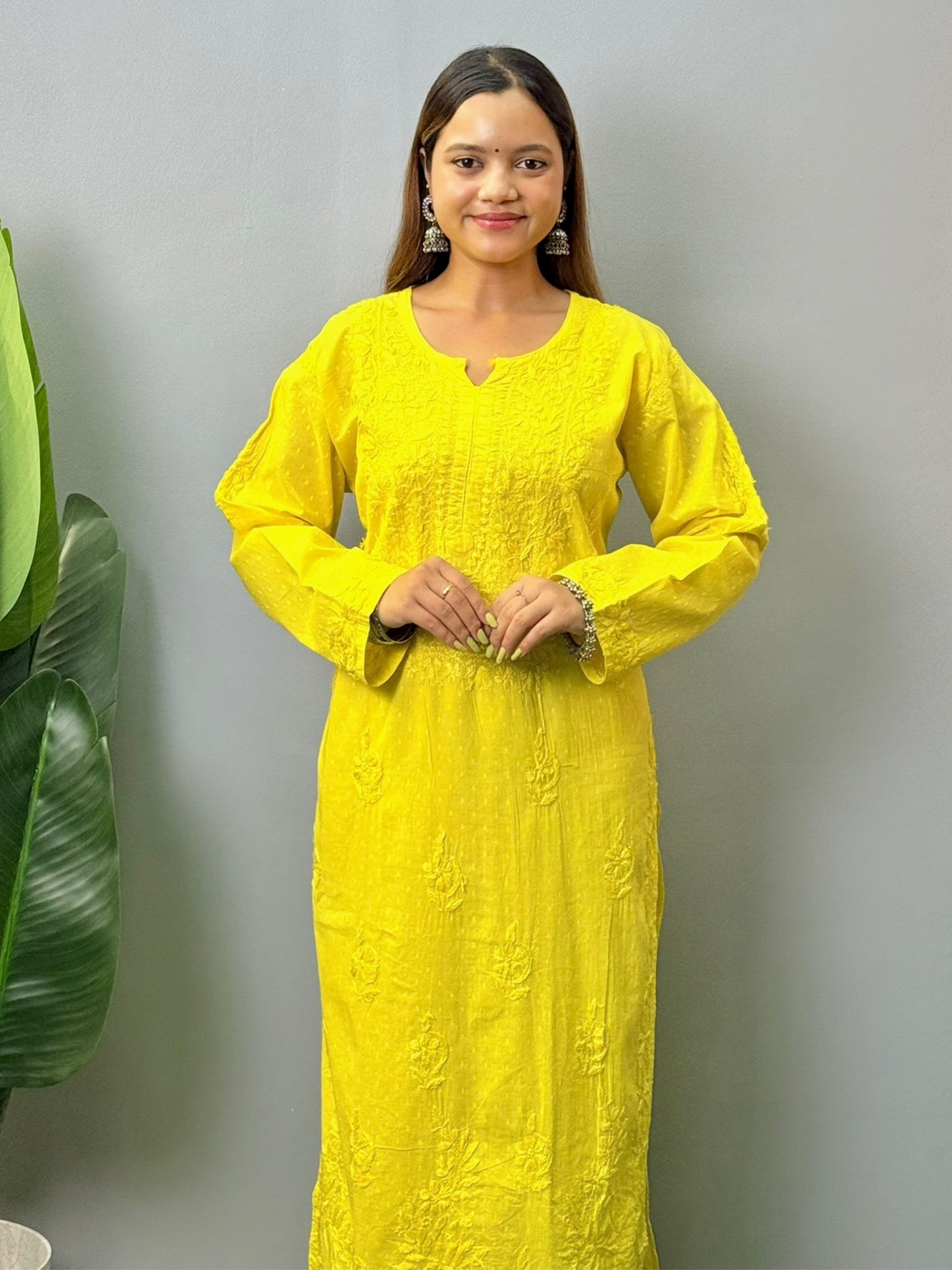 Model wearing bright yellow dobby cotton chikankari kurta and pant set