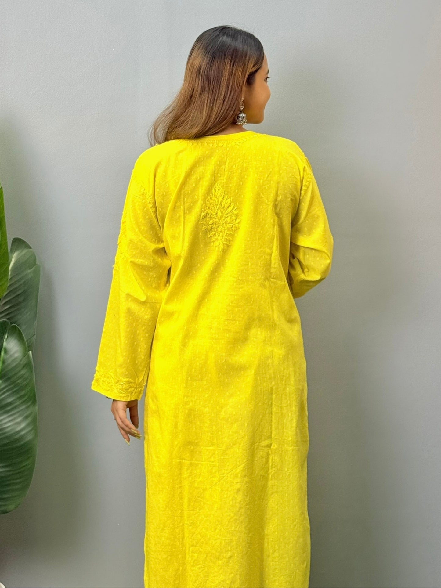 Model wearing bright yellow dobby cotton chikankari kurta and pant set