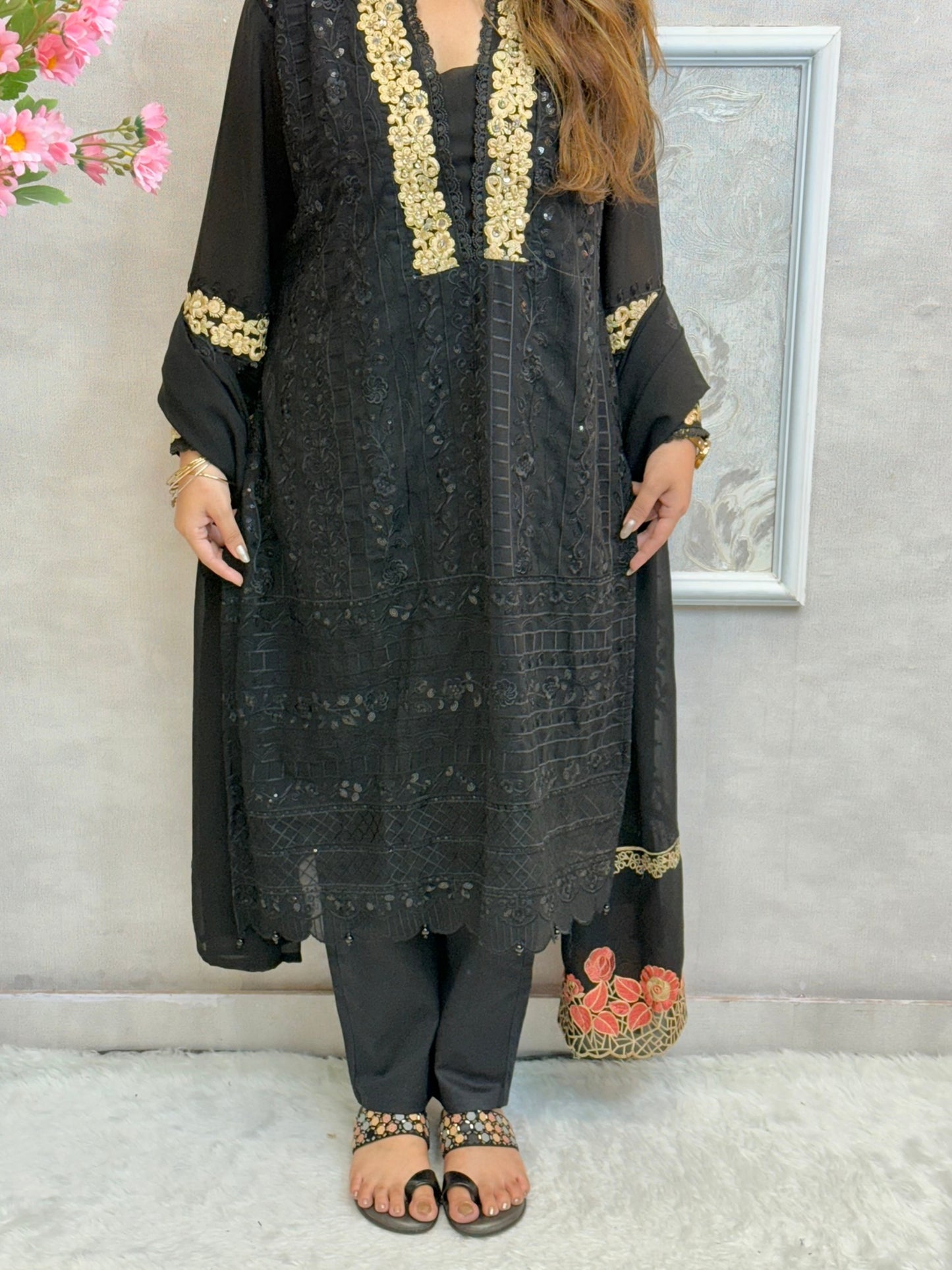 Black georgette kurta with gold zari embroidery, paired with cotton stretch pants and georgette dupatta