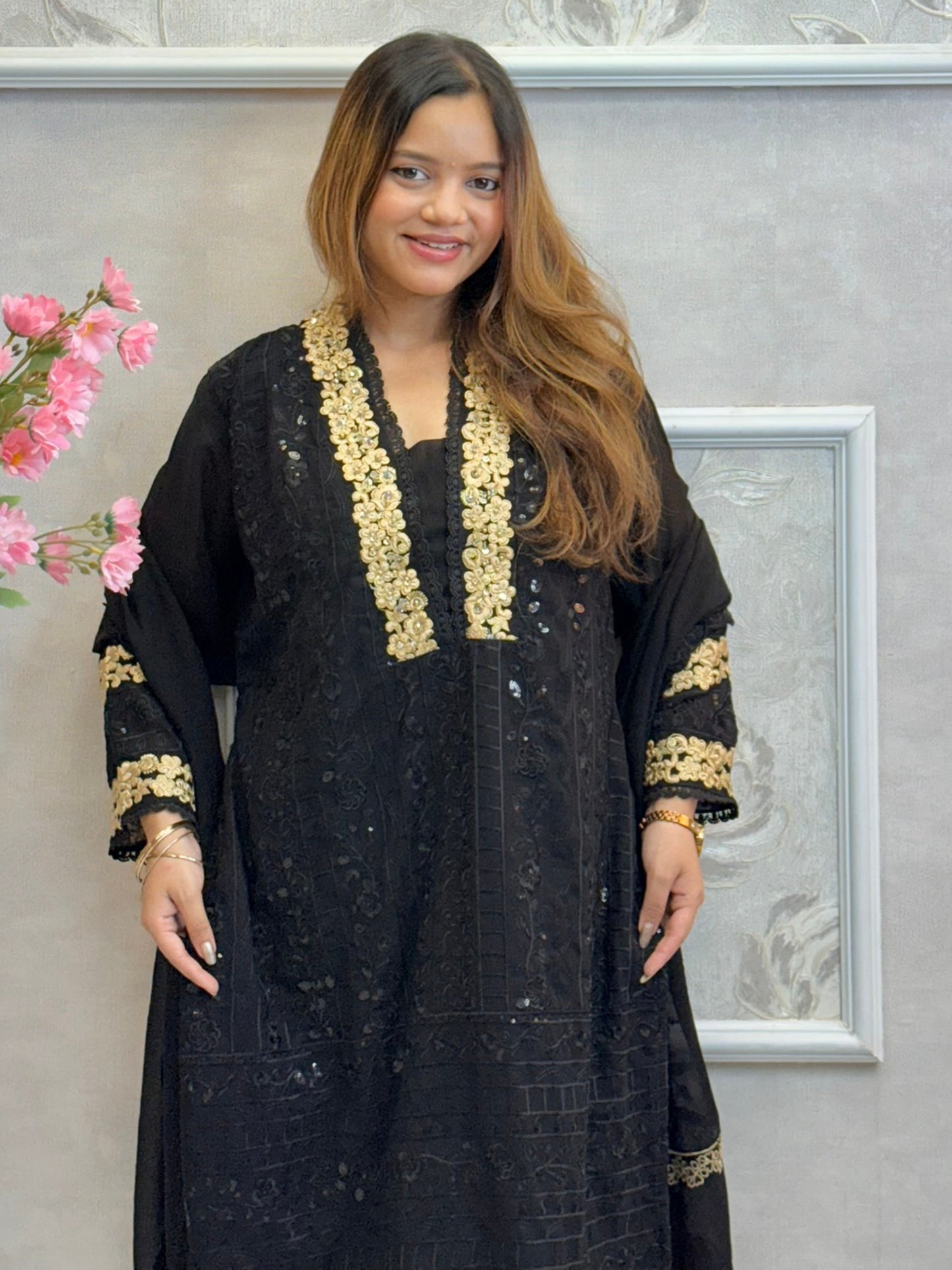 Black georgette kurta with gold zari embroidery, paired with cotton stretch pants and georgette dupatta