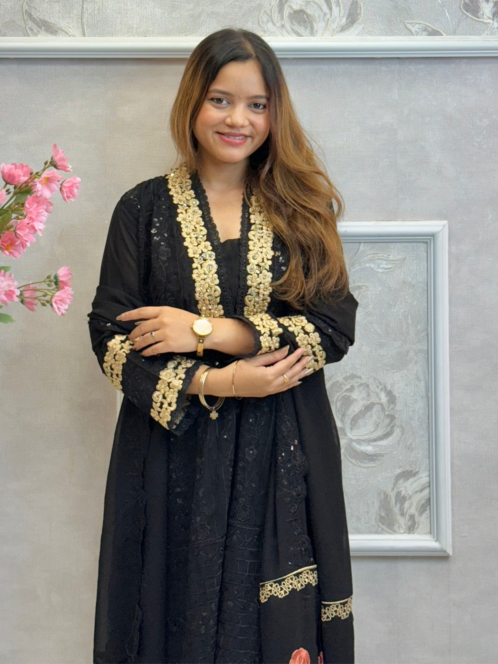 Black georgette kurta with gold zari embroidery, paired with cotton stretch pants and georgette dupatta