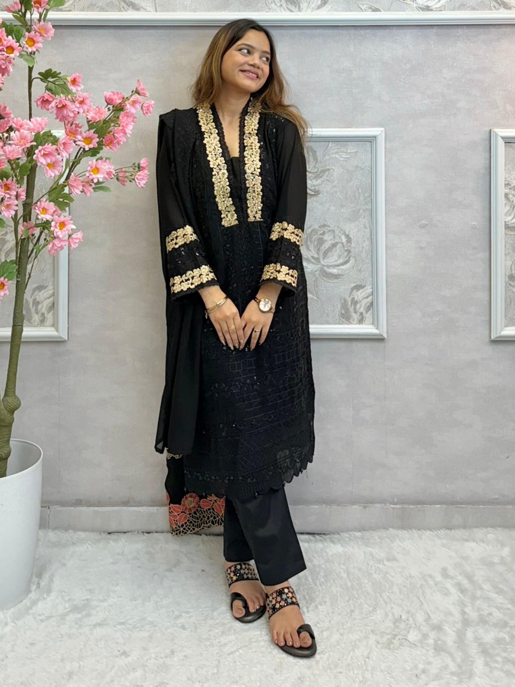 Black georgette kurta with gold zari embroidery, paired with cotton stretch pants and georgette dupatta