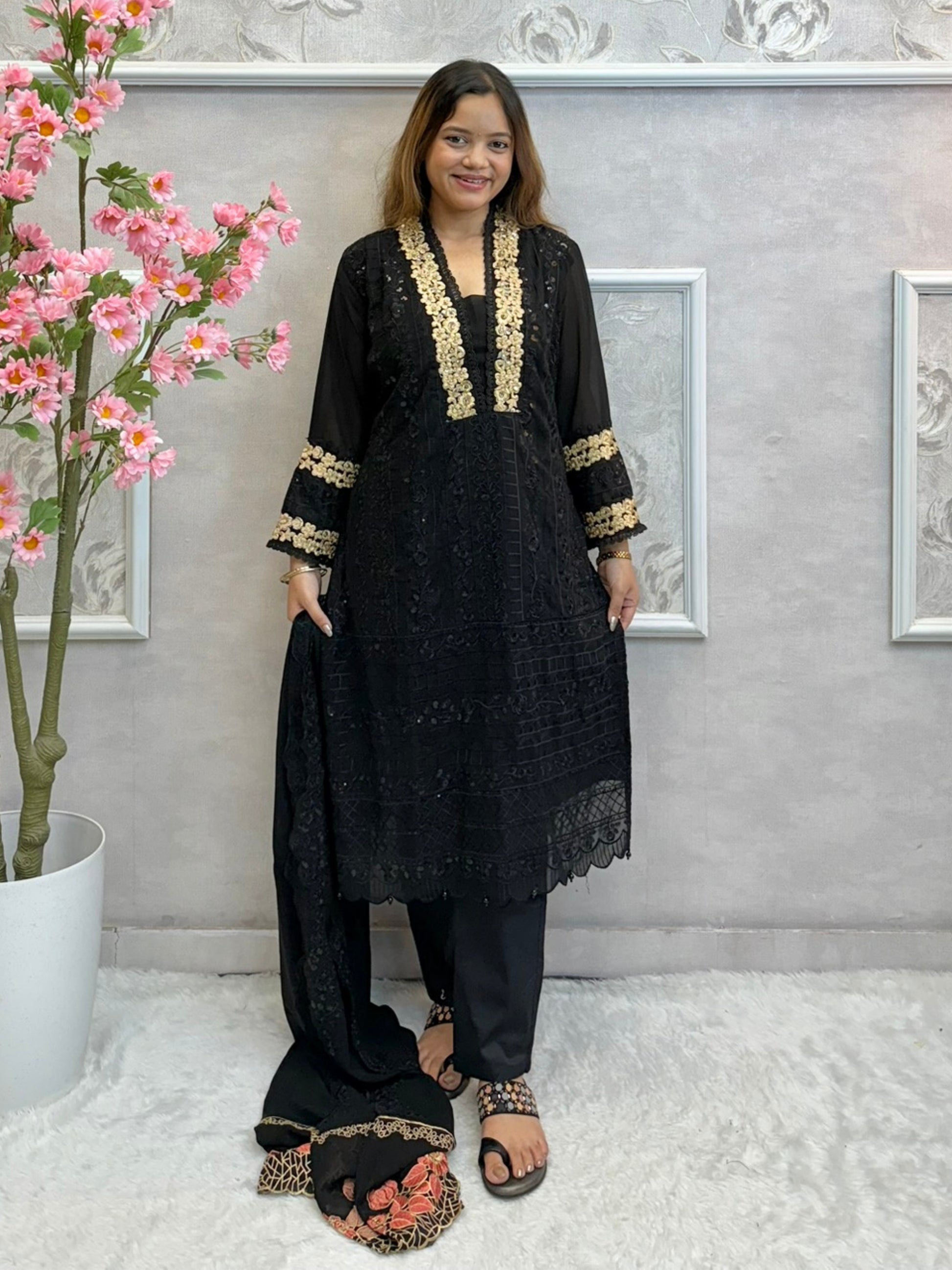 Black georgette kurta with gold zari embroidery, paired with cotton stretch pants and georgette dupatta