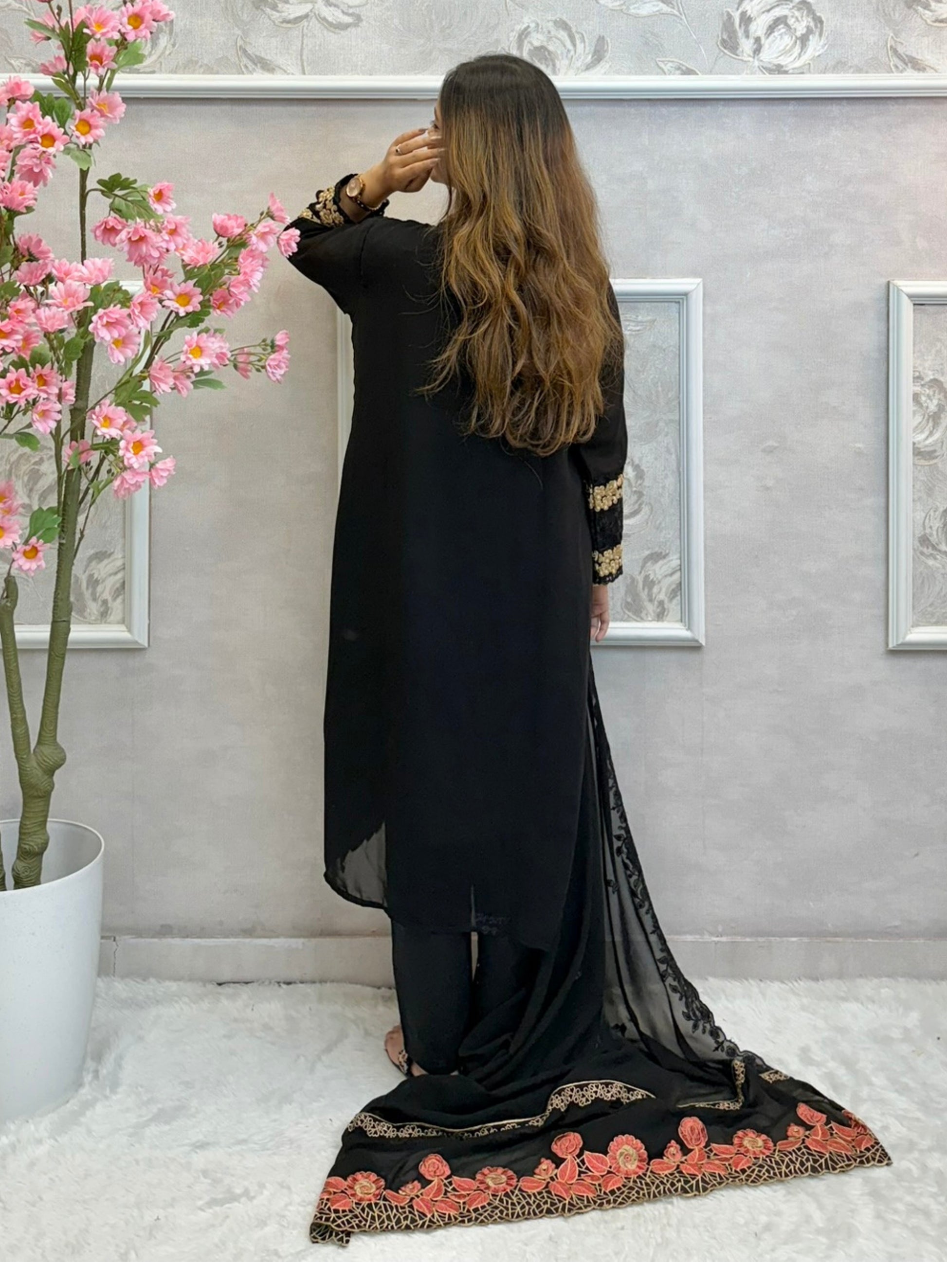 Black georgette kurta with gold zari embroidery, paired with cotton stretch pants and georgette dupatta