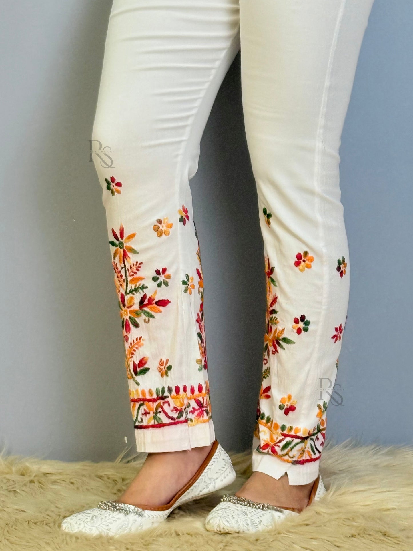 White chikankari cotton pant with multicolor floral embroidery and slit hem design