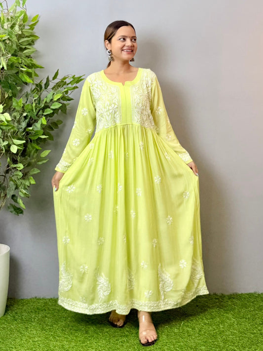 Model wearing a lime green Lucknowi chikankari long frock in modal fabric with delicate white hand embroidery and flared silhouette.
